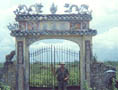 Leroy Ace in front of ornate mausoleum gate